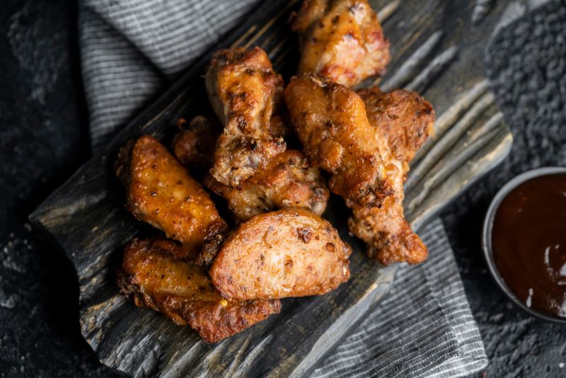 Chicken wings with buffalo sauce and celery sticks