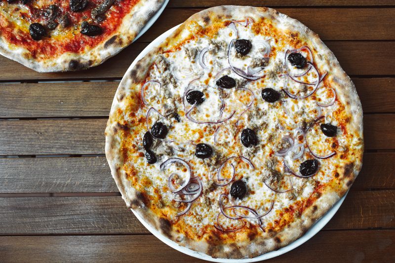 Margherita thin crust pizza with fresh basil and mozzarella